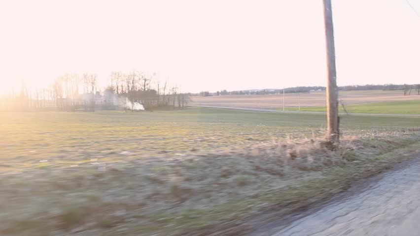 Fast car travels on country road

