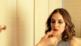 Visagiste applying make-up on brunette model's face close-up 4K closeup video