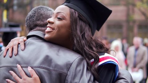 Graduation Day Celebration, With Happy Black Graduate Female Hugged By Proud Father. In Slow Motion.