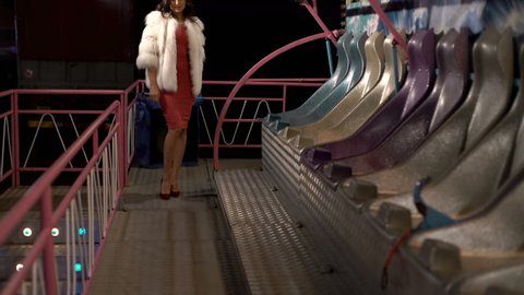 Seductive model in furry coat going on catwalk on balcony 4K