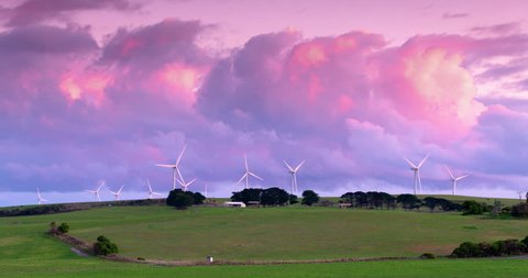 Wind farm on pretty farm with pink sky sunset in Cape Nelson, Australia. Stockvideo