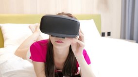 video of woman wear vr and look movie in living room on the bed