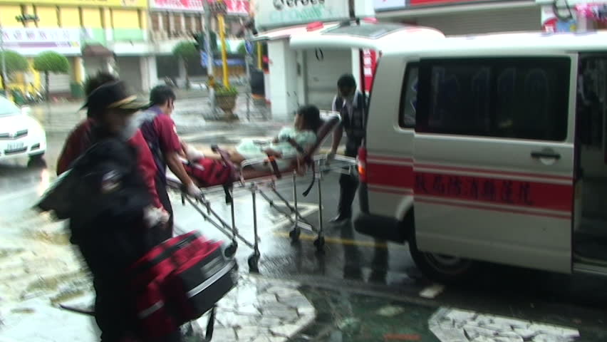 HUALIEN, TAIWAN - AUGUST 2009: Woman injured by flying debris during typhoon