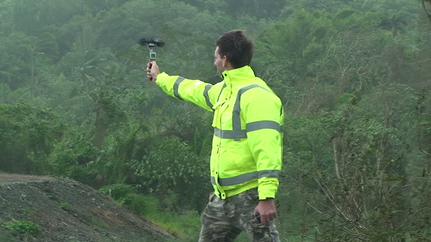 HUALIEN, TAIWAN - AUGUST 2009: Storm chaser measures strong winds as typhoon