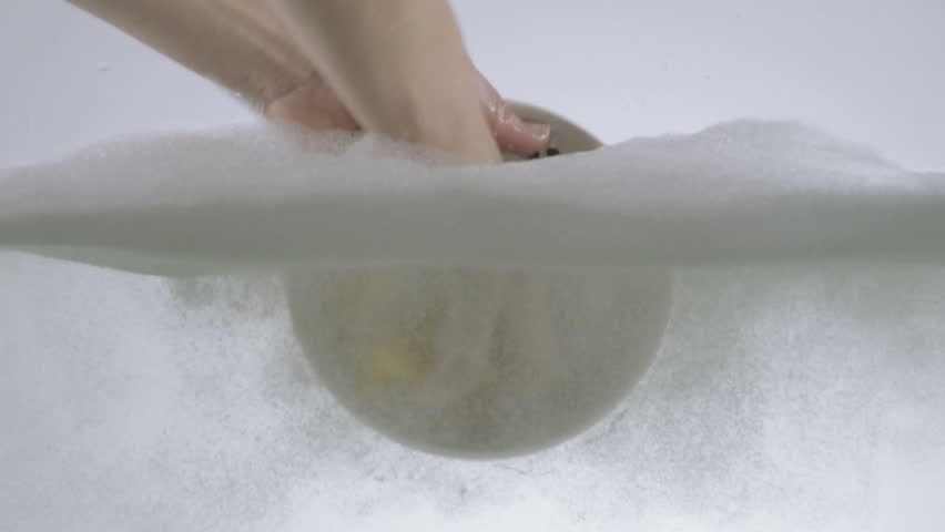 Slow Motion Shot Of Hands Washing Small Serving Bowl Using Washing Detergent And