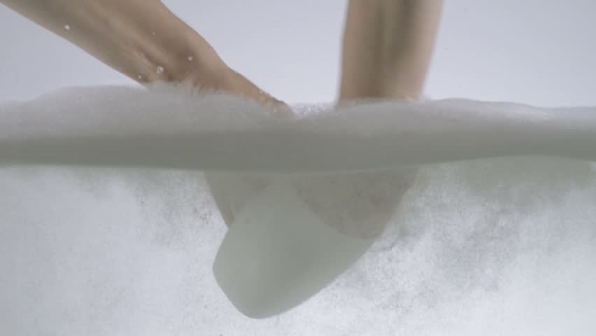 Slow Motion Shot Of Hands Washing White Cup Using Washing Detergent And Sponge 
