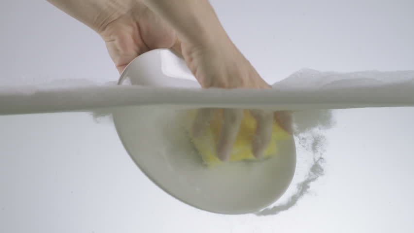 Hands Washing White Ceramic Plate Using Washing Detergent And Sponge. 