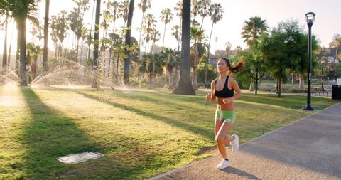 Athlete woman jogging in a park at dawn