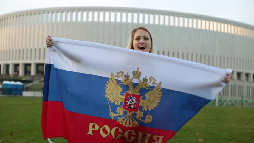 A woman with a big flag of Russia. Cup in Russia in 2018.