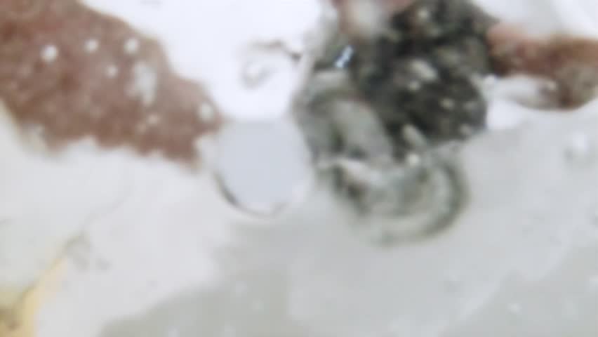 Camera pov of water filling a tub