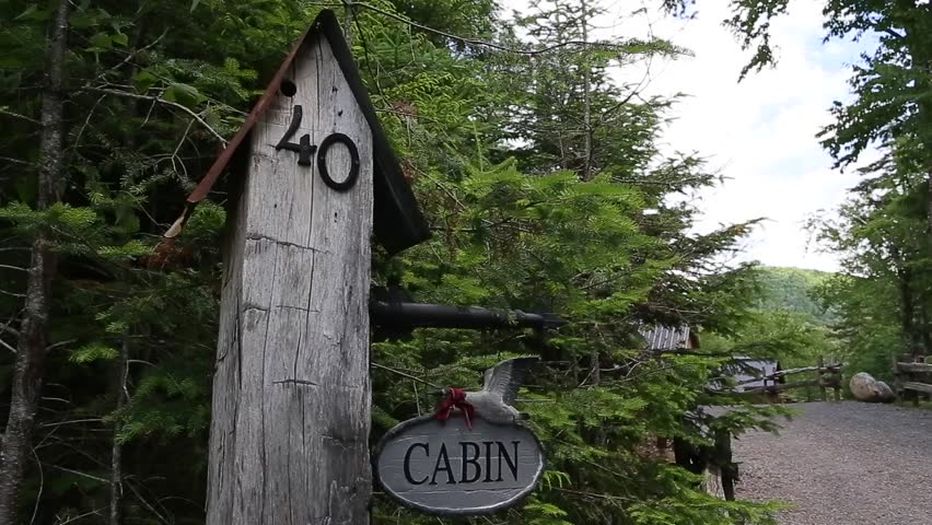 cabin address on wooden post with sign medium