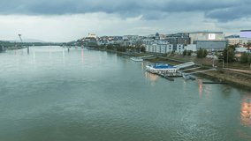 Danube waterfront video timelapse with clouds rain ships sunset with light turning on in old town bratislava slovakia
