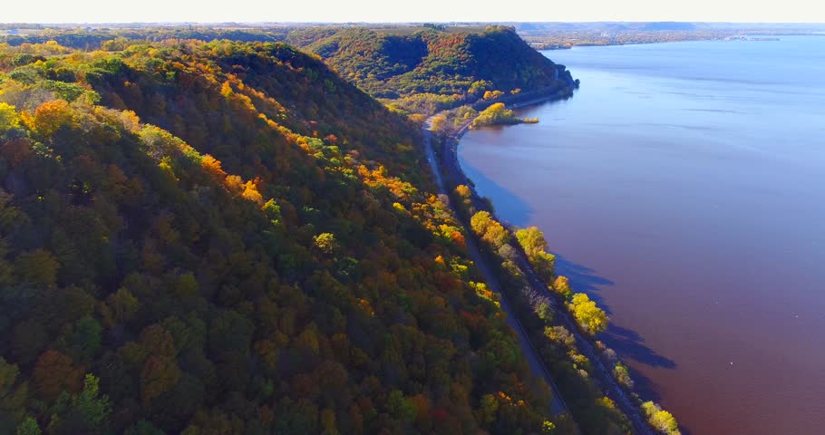 Aerial flyby of colorful Autumn hillsides overlooking vast Mississippi River, Minnesota.
