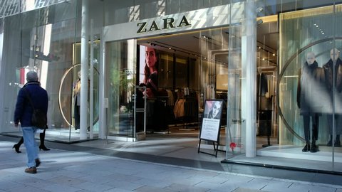 TOKYO, JAPAN - NOVEMBER 12TH, 2017. Woman walking into Zara outlet, the Spanish fashion retailer in Ginza street.