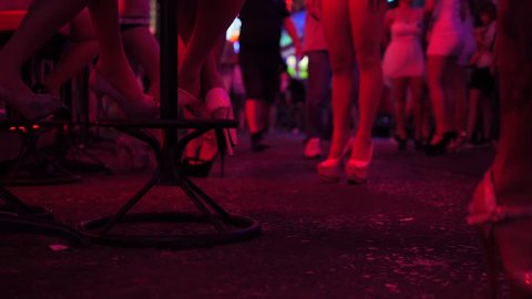 Strip Bar Girls in High Heels Shoes Waiting for Clients at Soi Cowboy Street. 4K. Popular Red District for Sexual Tourism in Bangkok, Thailand.