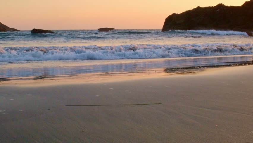 Sandy beach waves and foam at sunset Harris Beach Oregon Coast Oregon