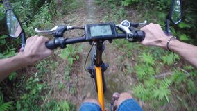 First person view of a ride along a nature trail in Phuket Thailand. on an electric bicycle with digital data dislay. UHD 4k video