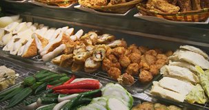 Assortment of tasty foods. including vegetables. seafood and more. at a popular Chinese buffet restaurant in Singapore. 4k DCI video