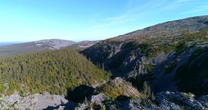 Tunturi mountains, Cinema 4k aerial view flying in isokuru, a canyon between two fjeld mountains, in pyha-luosto national park of Lapland, on a sunny autumn day, in Lappi, Finland