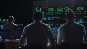 Financial traders working in modern office analyzing statistics and driving trade on exchange. - Powered by Shutterstock - Get 15% off with code: PIKWIZARD15