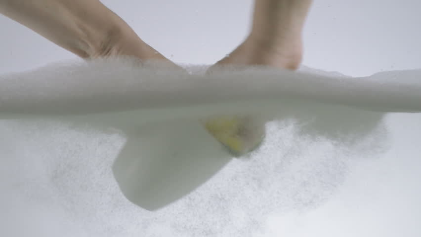 Hands Washing A White Ceramic Cup Using Detergent And Sponge 