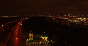 4K high quality aerial video scenic night view of monumental imposing Moscow State University main building overlooking Moscow River, in city hills in south-western part of Moscow, Russia