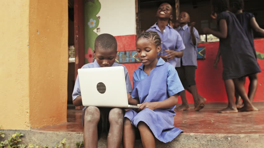 4k of African students / pupils using laptop computer during lunch break at school.
