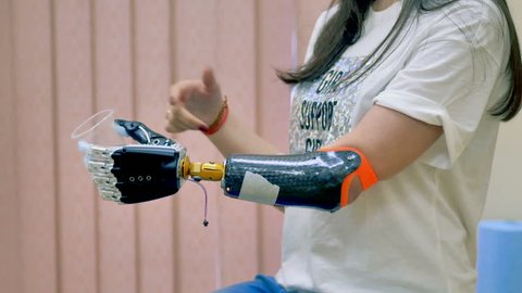 Human uses innovative robotic bionic arm. 4K.