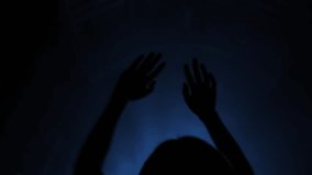 Spectator fan girl silhouette dance raise hands enjoy listen to music concert in light lumiere