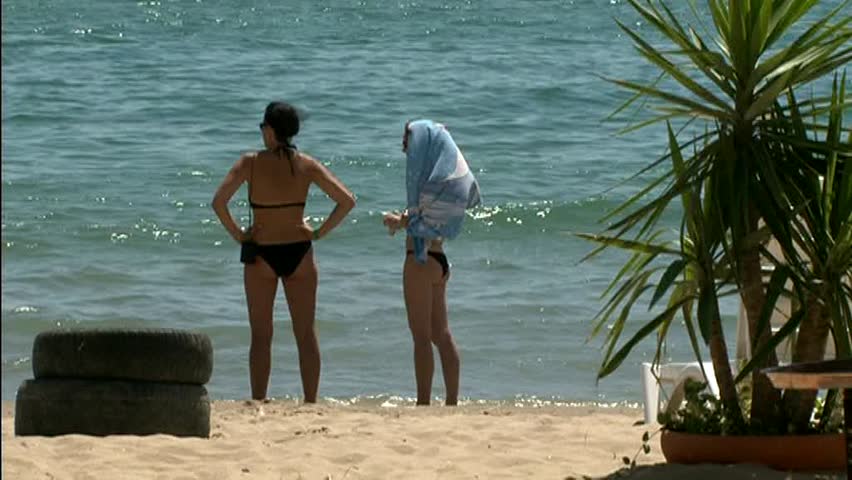 Young women standing on the beach