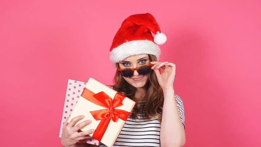 Portrait of beautiful smiling girl holding christmas gift box in hands. Slow motion. | Shutterstock HD Video #33020311