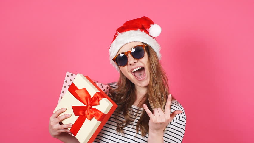 Portrait of beautiful smiling girl holding christmas gift box in hands. Slow motion. | Shutterstock HD Video #33020320