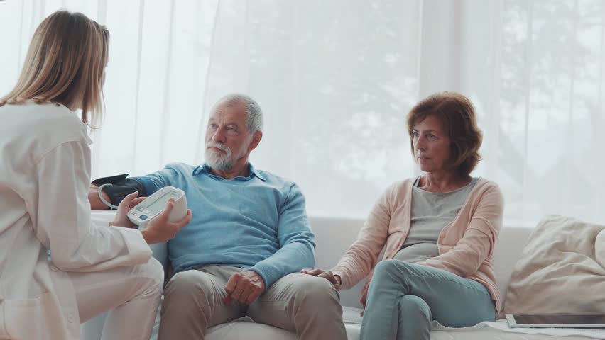 Female doctor checking blood pressure of senior man. | Shutterstock HD Video #33023467