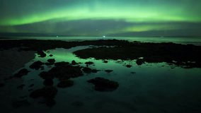 Aurora borealis reflecting green in calm ocean tidal pool water Iceland
 - Powered by Shutterstock - Get 15% off with code: PIKWIZARD15