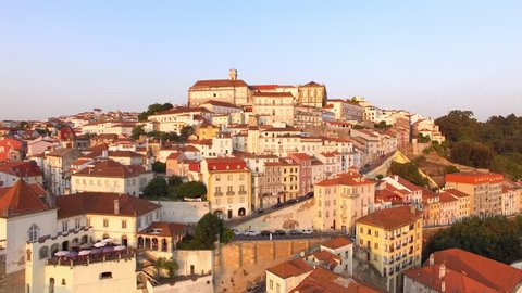 Coimbra, Portugal, aerial view of cityscape including the famous University of Coimbra and Clock Tower at sunset.