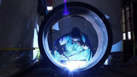 Welder inside Pipe, Welding the Seam to Create One Continuous Section of Pipe.