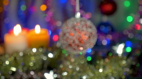 A beautiful red ball. New Year and Christmas decorations. Flashing Garlands. Blurred background.
