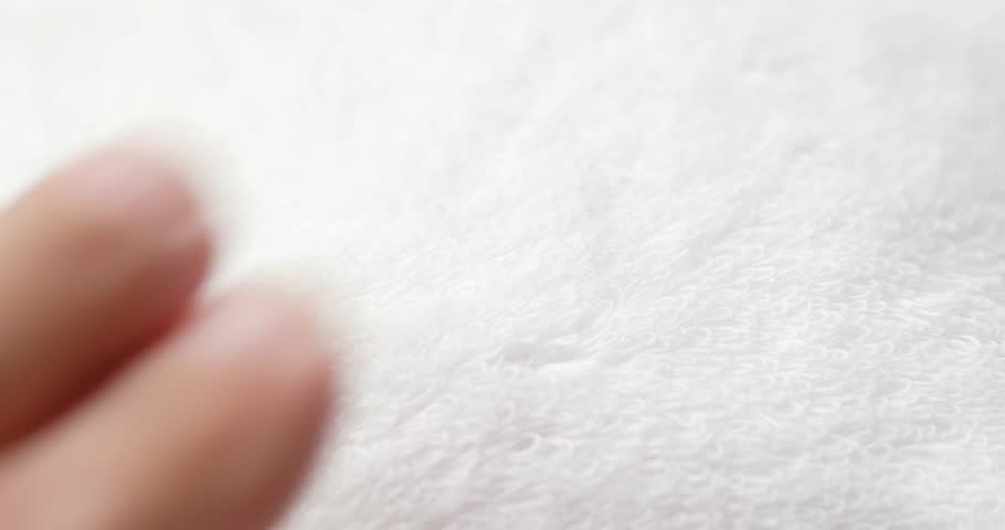 Hand touch on white towel