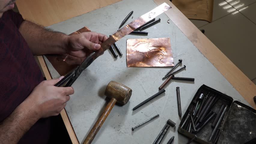 Close-up copper-smith work. Art smiting work progress  