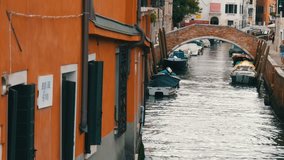 VENICE, ITALY, SEPTEMBER 7, 2017: Cozy beautiful Venetian canal with a bridge and beautiful colorful houses