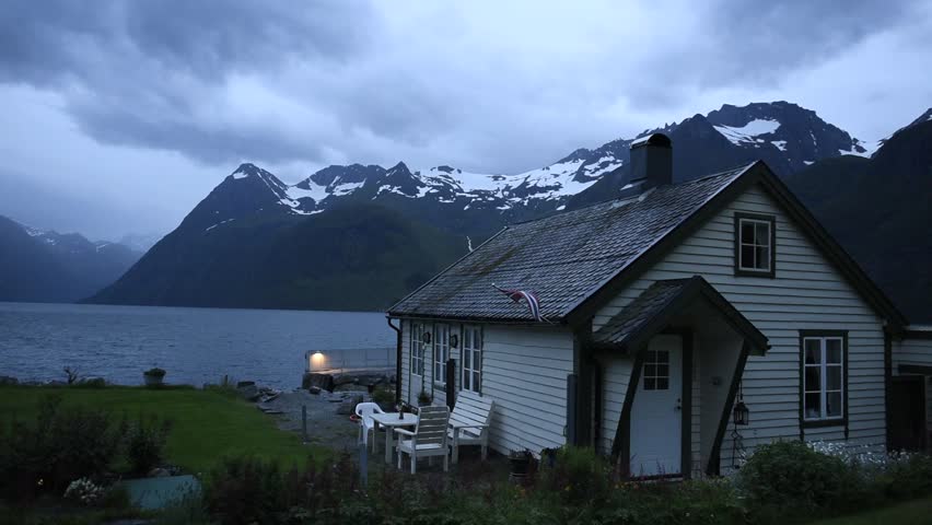 Picturesque evening scene with house in Urke village and Hjorundfjorden fjord, Norway
