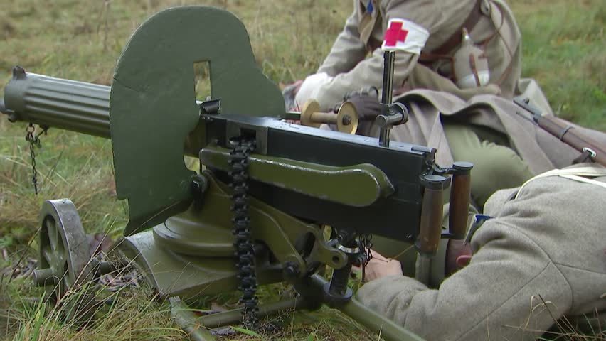A military nurse bandages a wounded soldier-machine gunner on the battlefield. Machine-gun crew of the Russian army.Reconstruction of the events of the First World War in 1914-1918.