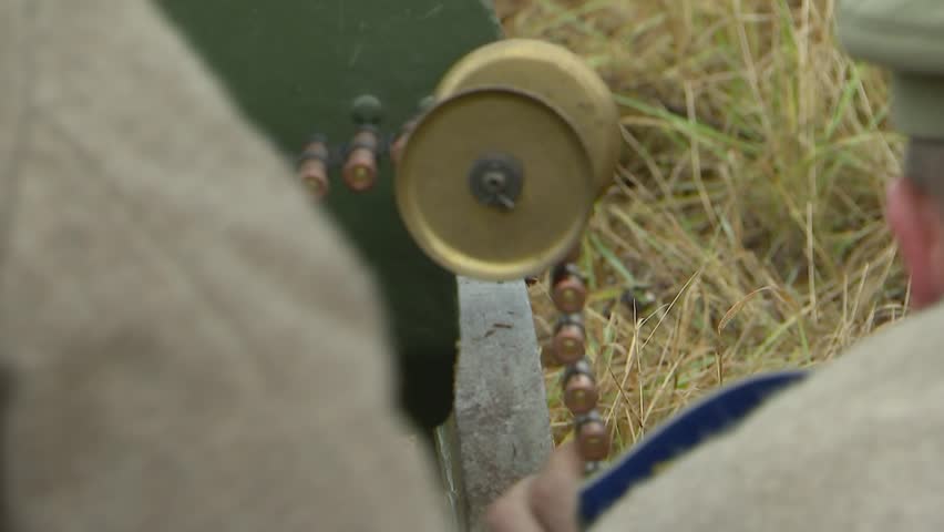 Russian Russian machine gun crew consisting of two soldiers of the old Russian army serves the Maxim machine gun. Preparation for shooting, machine gun tape.Reconstruction of the First World War.