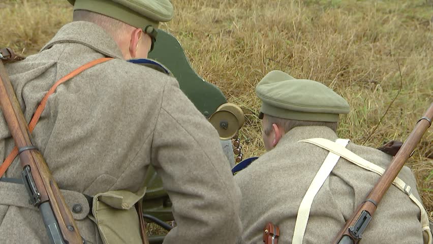 Russian Russian machine gun crew, consisting of two soldiers of the old Russian army, serves the Maxim machine gun, general plan. Preparation for shooting, machine gun tape.