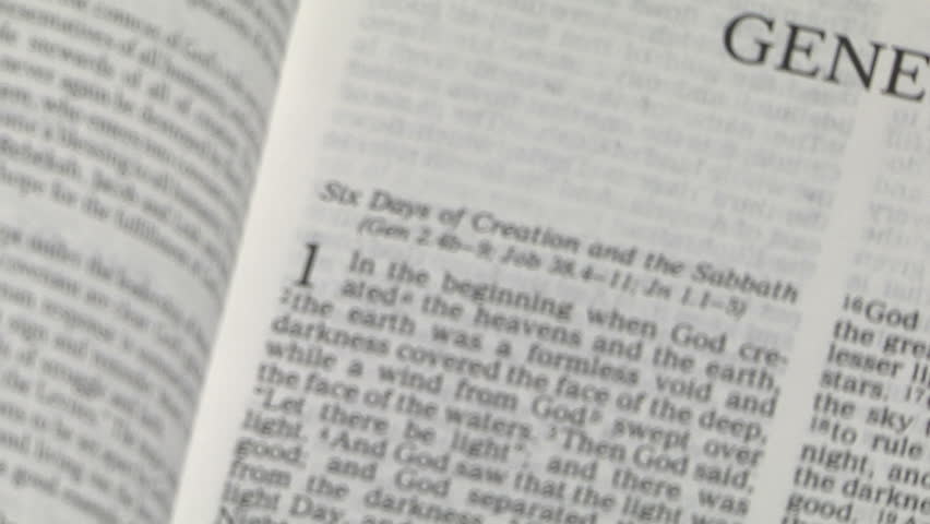 magnifying glass focuses on the first passage of genesis in the bible