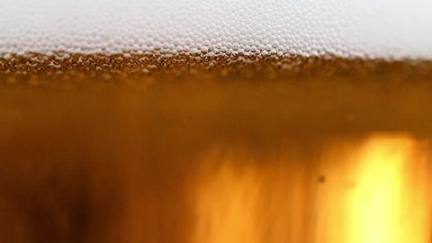 Foam and air bubbles in a glass of light beer