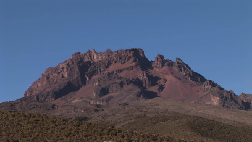 A team of hikers summiting Mt. Kilimanjaro, make their way towards the saddle of Mt. Mawenzi and Kilimanjaro. Video footage from the old