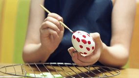 Little girl Painting Easter eggs