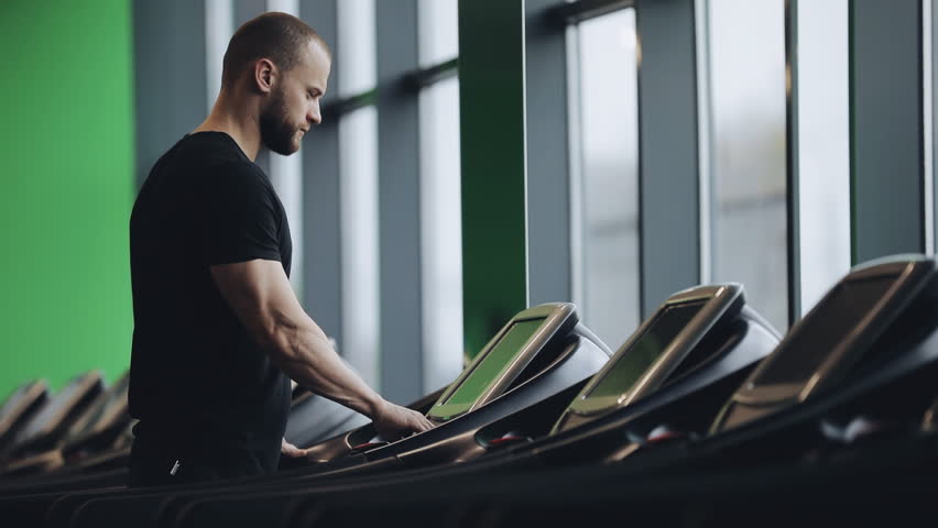 Man run on treadmill, slow motion