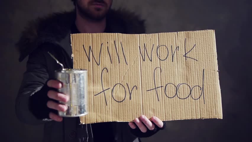 homeless hold out a tin and a cardboard with a sign